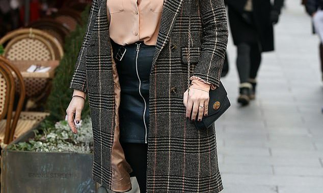 Kelly Brook shows off her slimmed down frame in a leather miniskirt as she nears the end of her month-long vegan stint