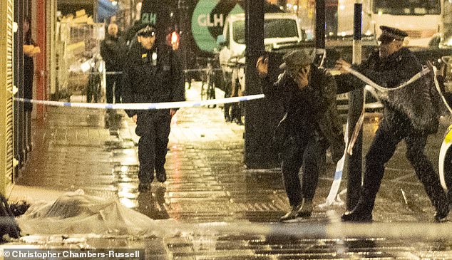 Moment horrified parents are held back by police as they try to reach their son, 17, as he lay dying in the street after being fatally stabbed over his bicycle in eighth murder in the capital this year