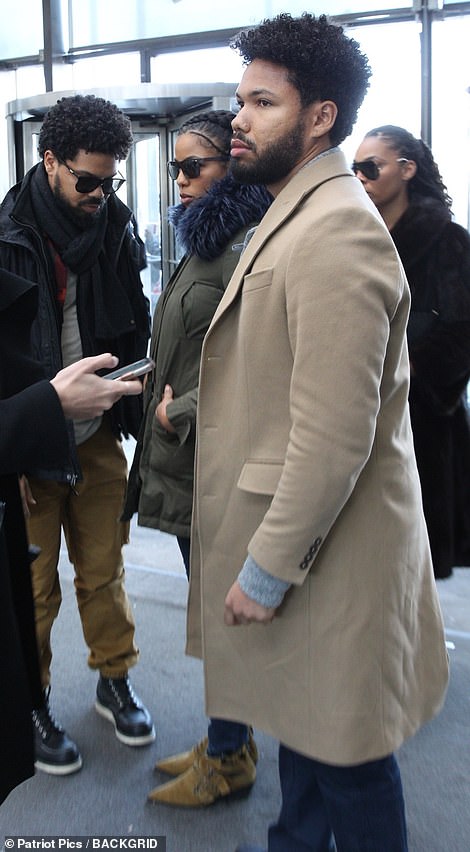 Jocqui (in beige coat), Jake (in black, right) and Jazz Smollett (center in fur-trimmed coat) arrive at the Cook County