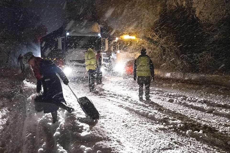Snow way home- Thousands of drivers are TRAPPED on 'ice rink' motorways and an entire town is blocked off as as forecasters warn Britain faces MORE snow and black ice