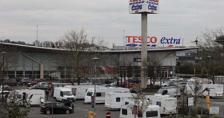 Shoppers are stunned as travellers in their dressing gowns pitch up with nearly a dozen caravans at Tesco car park near Wembley Stadium