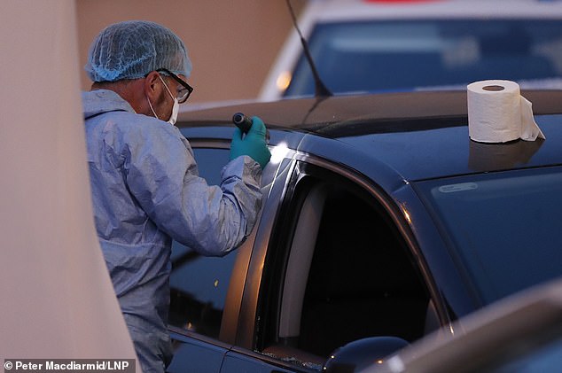 The victim is believed to have driven into a lamp post as he desperately tried to escape three chasing men (pictured, the crashed vehicle)