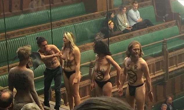 Semi-naked climate change protesters interrupt Commons debate on Brexit as they storm public gallery and GLUE themselves to the glass protecting MPs (and Ed Miliband can’t believe his eyes)