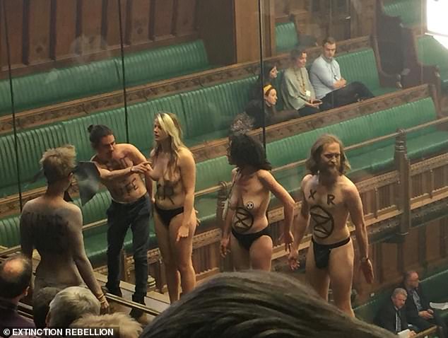 Semi-naked climate change protesters interrupted a Commons debate on Brexit tonight as they stripped off in the public galler