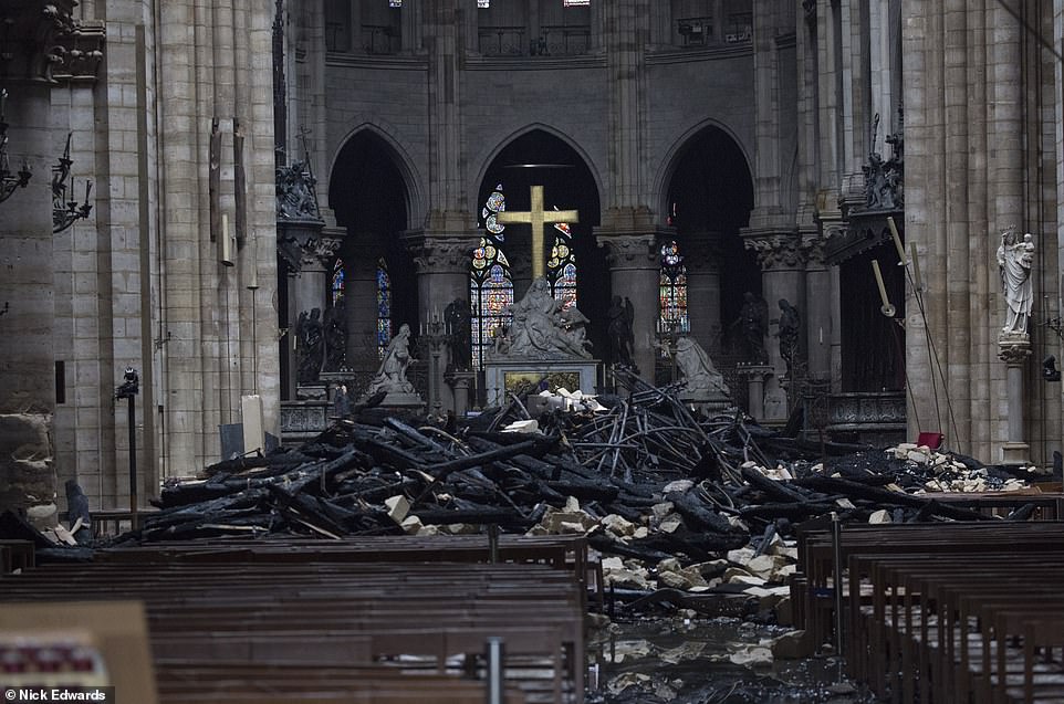 The preserved golden crucifix and altar within the wreckage of Notre Dame Cathedral in Paris